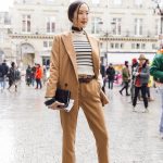 Chriselle Lim in stripped shirt and brown pantsuit at Paris Fashion Week photo by Armenyl.com