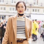 Chriselle Lim in stripped shirt and brown pantsuit at Paris Fashion Week photo by Armenyl.com